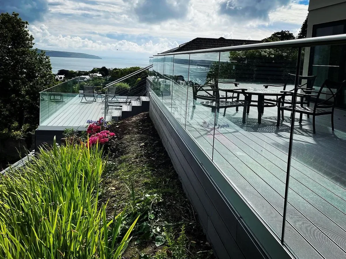 deck-glass-balustrade-coastal-deck-sea-view-swansea-swansea-glass-balustrades-hero Glass balustrade around a coastal deck with a sea view, installed by Swansea Glass Balustrades