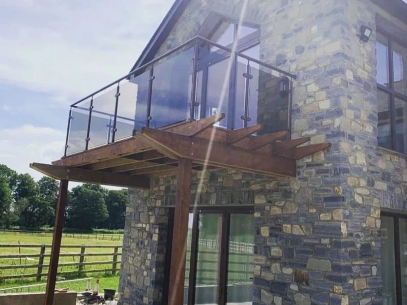 glass-balcony-glass-balcony-stone-house-timber-cantilever-swansea-swansea-glass-balustrades-wide Glass balcony balustrade showing glass balcony stone house timber cantilever in Swansea by Swansea Glass Balustrades