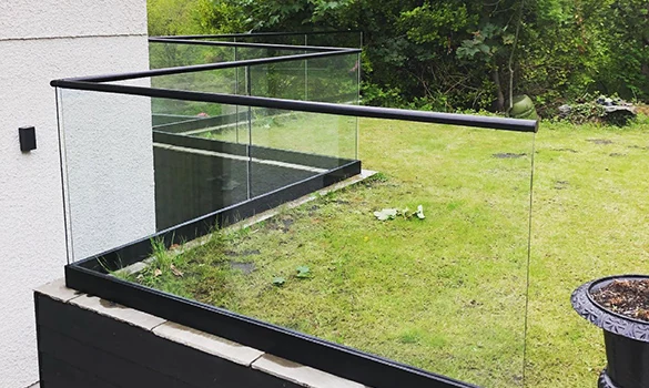 Outdoor glass balustrade showing frameless glass balustrade raised deck lawn in Swansea by Swansea Glass Balustrades