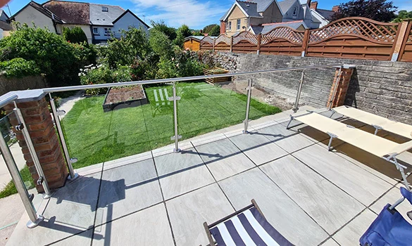 Outdoor glass balustrade showing glass balustrade paved garden terrace in Swansea by Swansea Glass Balustrades