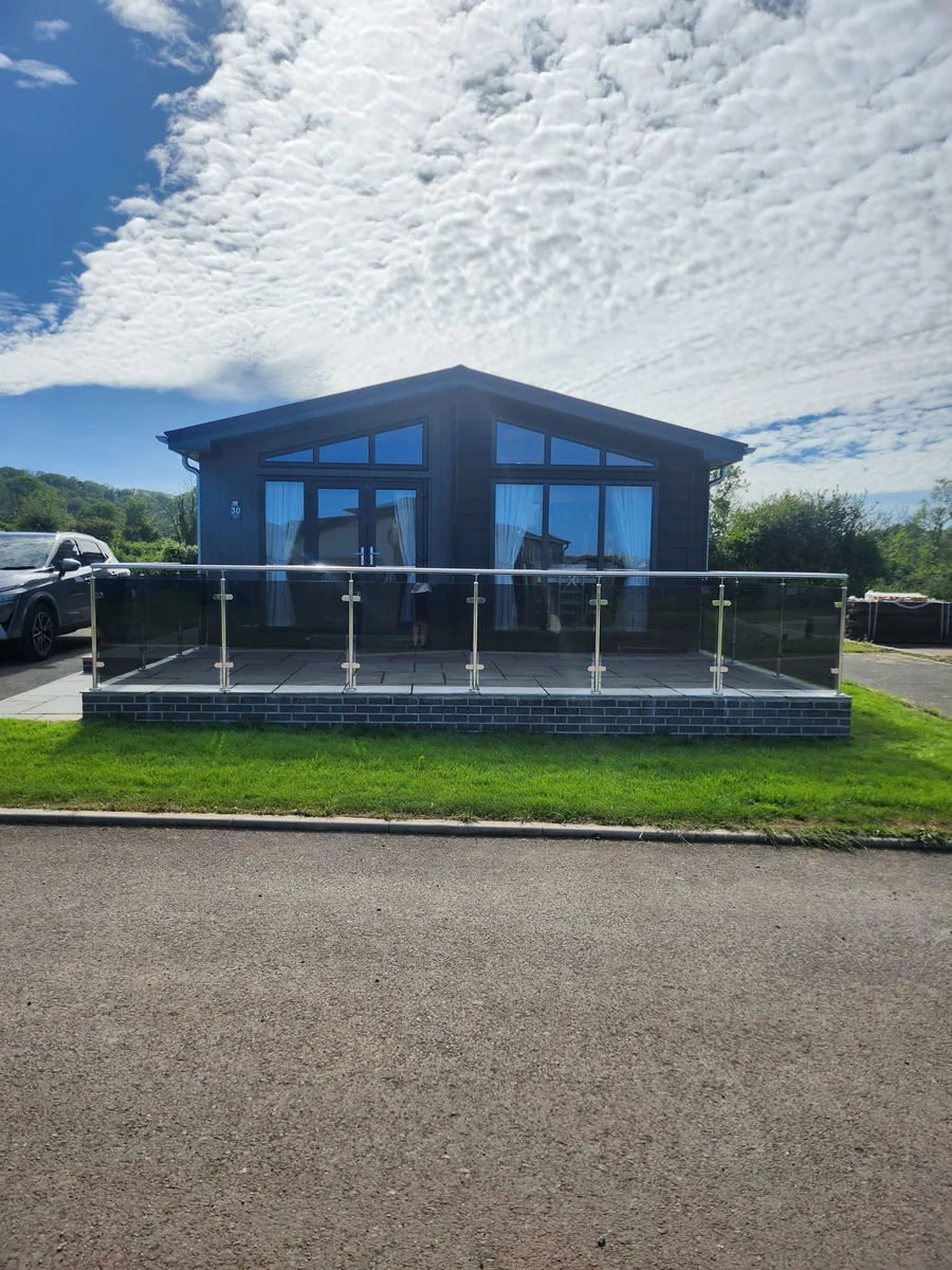 outdoor-glass-balustrade-lodge-full-width-view-swansea-swansea-glass-balustrades Outdoor glass balustrade showing lodge full width view in Swansea by Swansea Glass Balustrades