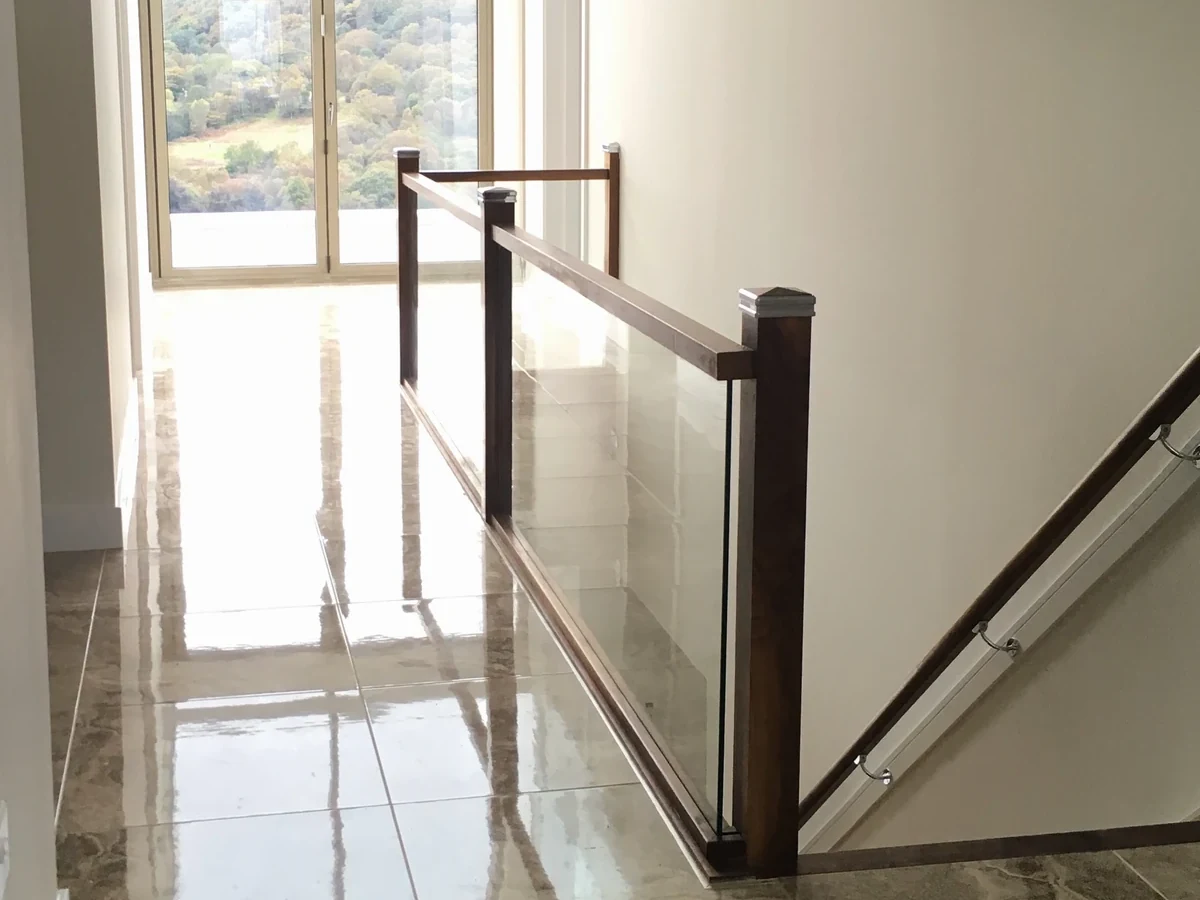 staircase-glass-balustrade-timber-rail-landing-swansea-swansea-glass-balustrades-wide Glass staircase and landing balustrade with timber rails in Swansea by Swansea Glass Balustrades